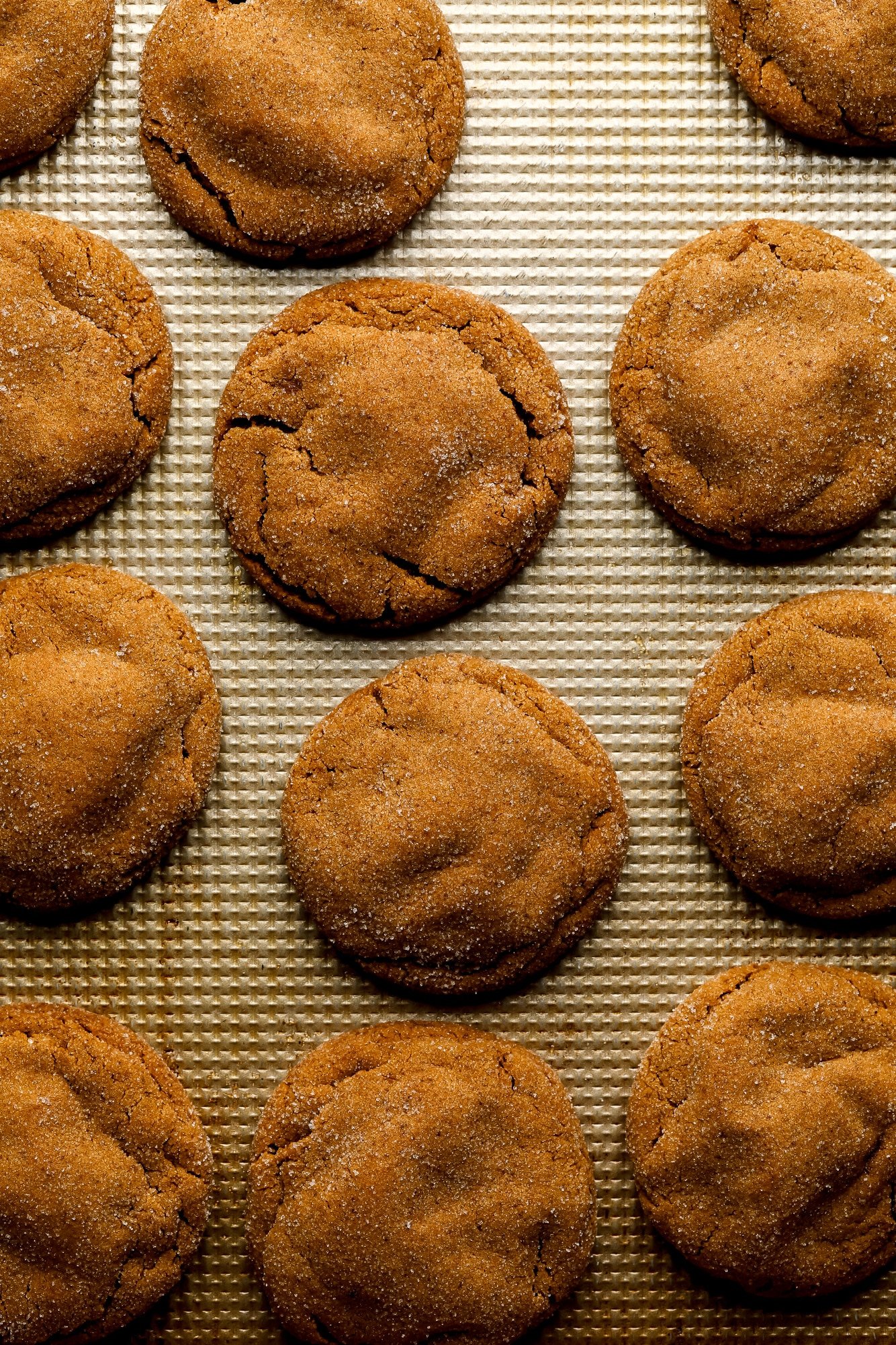 Cookies de café com leite de gengibre assados ​​em uma assadeira de metal.